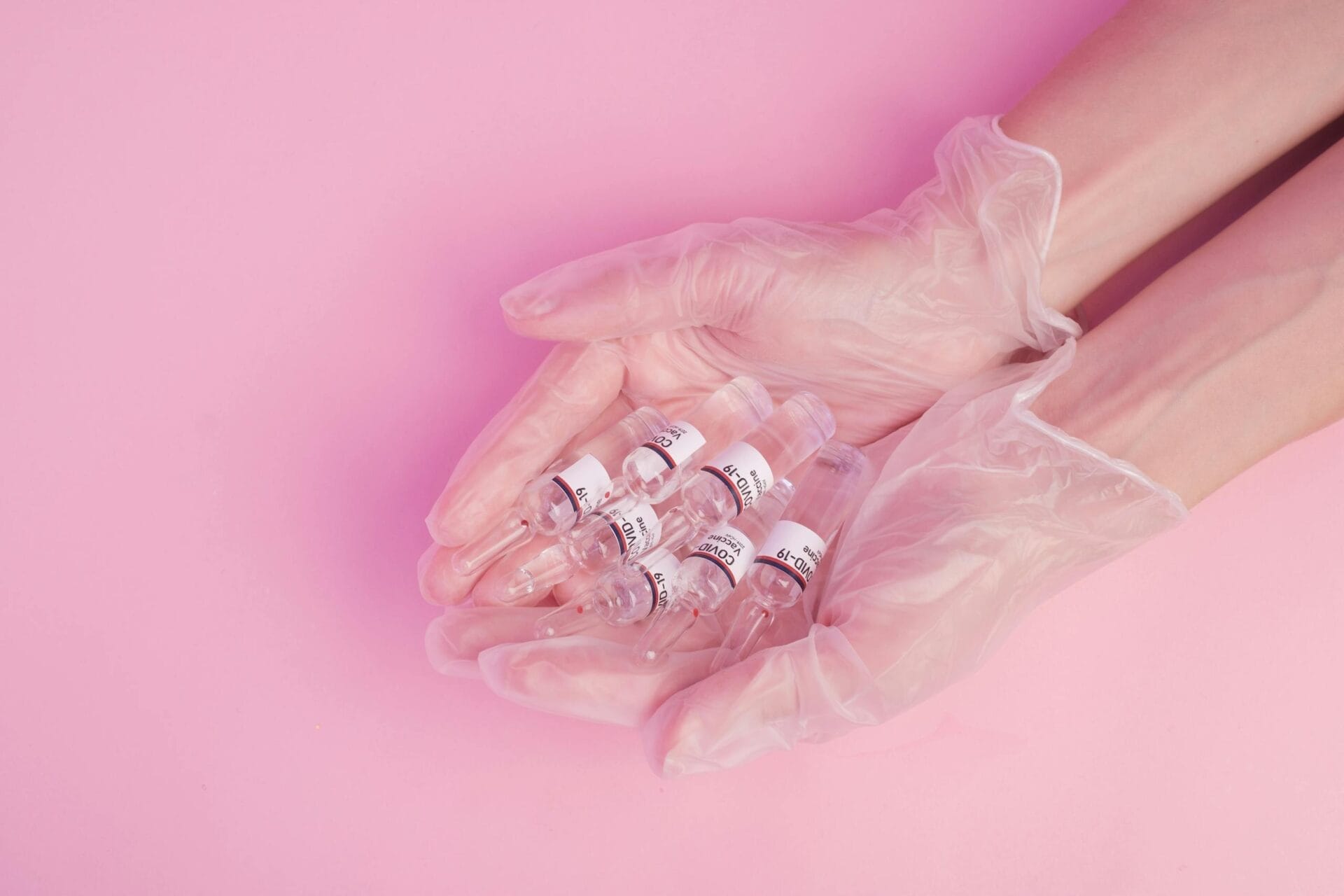 Anonymous woman demonstrating COVID 19 vaccine ampules in hands